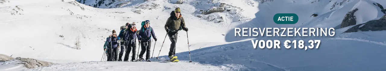 Een groep wandelaars op een besneeuwd bergpad met de tekst: Actie: Reisverzekering voor € 18,37.